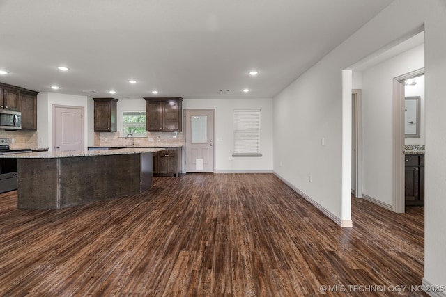 3923 Bryan Rd, Durant, OK 74701 - kitchen with stainless steel appliances, dark wood-style floors, dark brown cabinetry, and recessed lighting