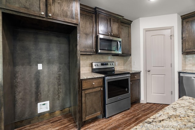 3923 Bryan Rd, Durant, OK 74701 - kitchen with appliances with stainless steel finishes, dark brown cabinets, dark wood finished floors, decorative backsplash, and light stone counters