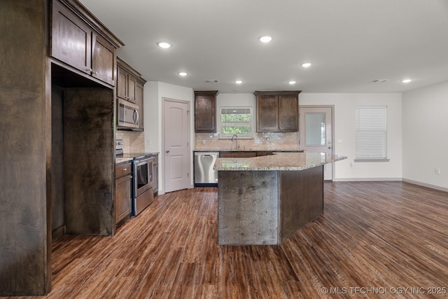 3923 Bryan Rd, Durant, OK 74701 - kitchen featuring stainless steel appliances, dark brown cabinetry, dark wood finished floors, backsplash, and recessed lighting