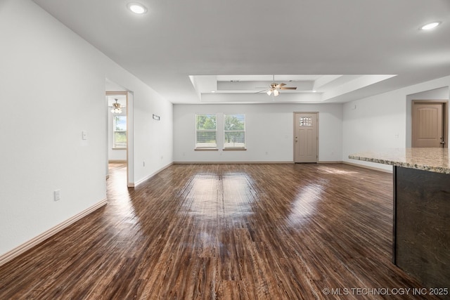 3923 Bryan Rd, Durant, OK 74701 - unfurnished living room with a ceiling fan, a tray ceiling, wood finished floors, baseboards, and recessed lighting