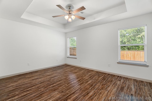 3923 Bryan Rd, Durant, OK 74701 - empty room with a tray ceiling, wood finished floors, and baseboards