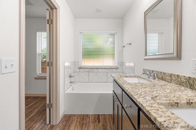 3923 Bryan Rd, Durant, OK 74701 - full bath with vanity, wood finished floors, and a garden tub