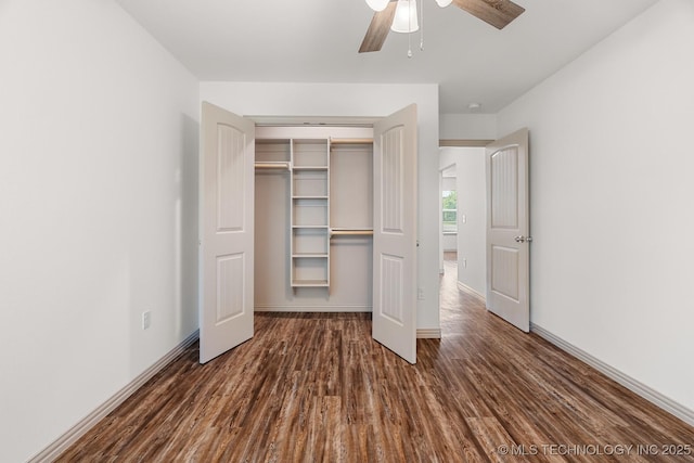 3923 Bryan Rd, Durant, OK 74701 - unfurnished bedroom featuring dark wood-style floors, a closet, baseboards, and ceiling fan
