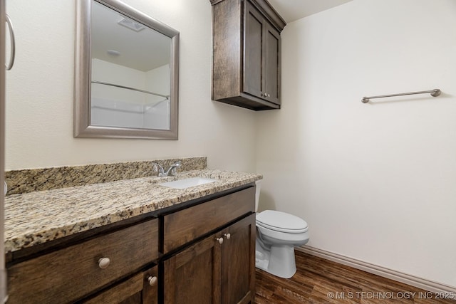 3923 Bryan Rd, Durant, OK 74701 - full bath featuring vanity, wood finished floors, toilet, and a shower
