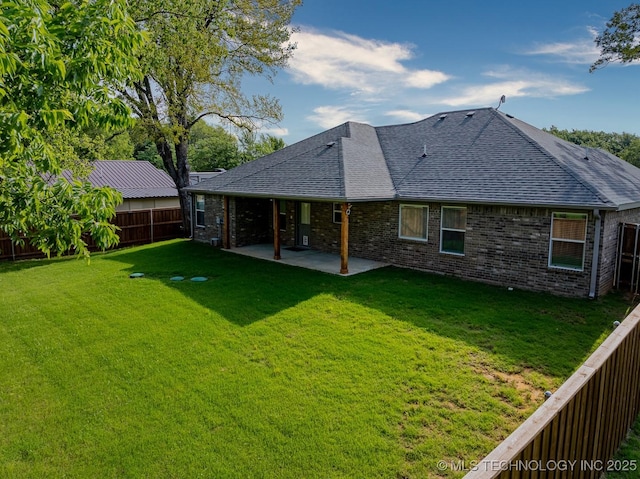 3923 Bryan Rd, Durant, OK 74701 - back of property featuring a shingled roof, a patio area, and brick siding