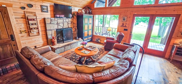 116433 S 4210th Rd, Eufaula, OK 74432 - living room featuring wood walls, wood-type flooring, lofted ceiling, and a stone fireplace