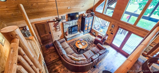 116433 S 4210th Rd, Eufaula, OK 74432 - living area featuring wood walls, ceiling fan, a fireplace, hardwood / wood-style flooring, and high vaulted ceiling