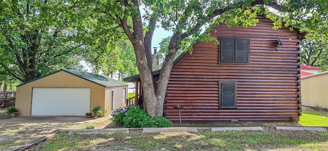 116433 S 4210th Rd, Eufaula, OK 74432 - view of side of property with log exterior, an outbuilding, a garage, and driveway