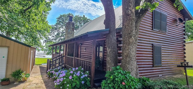 116433 S 4210th Rd, Eufaula, OK 74432 - view of side of home featuring log exterior, a chimney, and metal roof