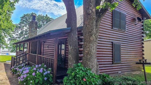 116433 S 4210th Rd, Eufaula, OK 74432 - view of side of property featuring log siding, a chimney, and metal roof