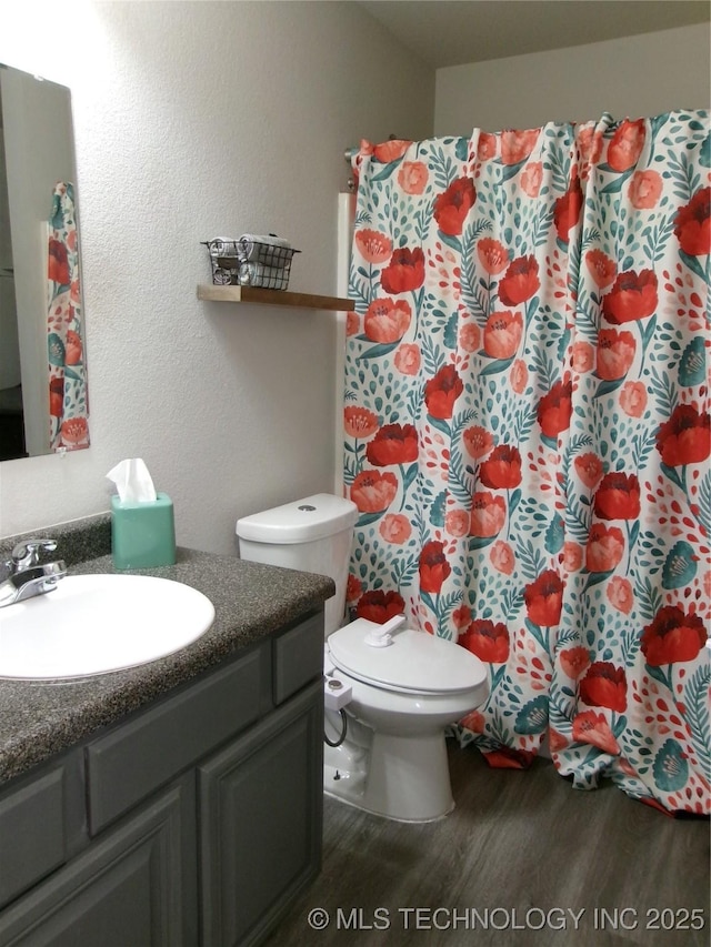 7882 E 132nd Pl S, Bixby, OK 74008 - full bathroom with wood finished floors, vanity, a shower with shower curtain, and toilet