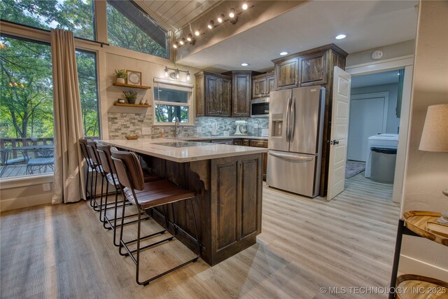 18341 W Woodhaven, Cookson, OK 74427 - kitchen with stainless steel appliances, light wood finished floors, a peninsula, lofted ceiling, and healthy amount of natural light