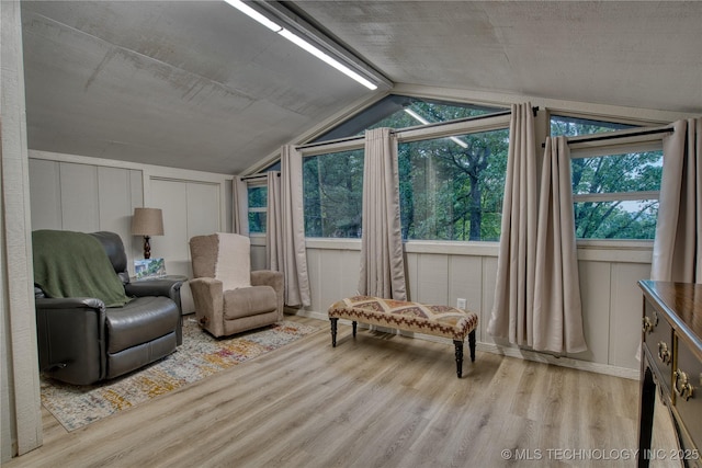 18341 W Woodhaven, Cookson, OK 74427 - sitting room with wood finished floors, lofted ceiling, and a decorative wall
