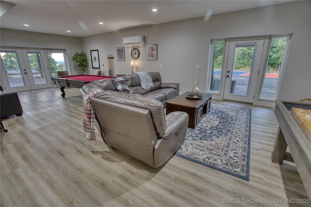 18341 W Woodhaven, Cookson, OK 74427 - living room featuring a wall mounted AC, french doors, billiards, light wood-style floors, and healthy amount of natural light