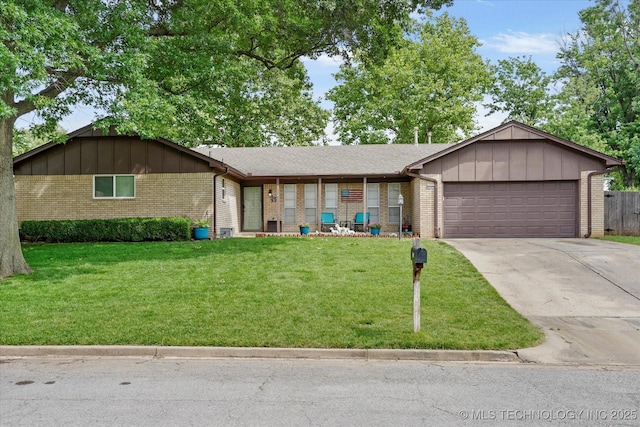 7329 E 66th Ct, Tulsa, OK 74133 - ranch-style house with brick siding, an attached garage, concrete driveway, board and batten siding, and a front yard