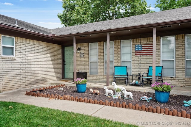 7329 E 66th Ct, Tulsa, OK 74133 - property entrance with brick siding and roof with shingles