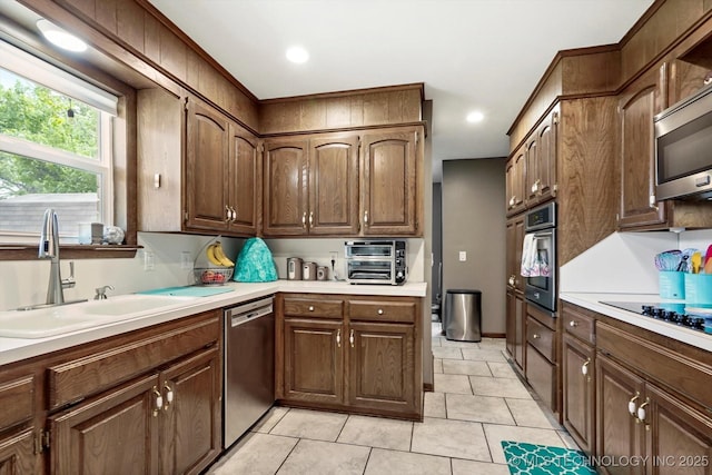 7329 E 66th Ct, Tulsa, OK 74133 - kitchen featuring stainless steel appliances, a sink, light countertops, light tile patterned floors, and recessed lighting