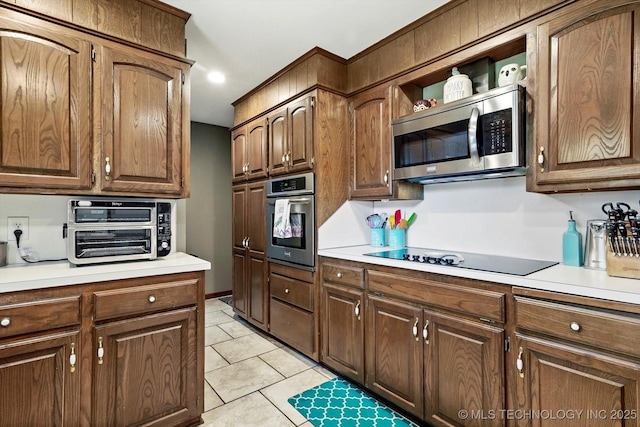 7329 E 66th Ct, Tulsa, OK 74133 - kitchen with appliances with stainless steel finishes, light countertops, light tile patterned floors, and open shelves