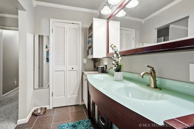 7329 E 66th Ct, Tulsa, OK 74133 - bathroom featuring a closet, double vanity, baseboards, ornamental molding, and tile patterned floors