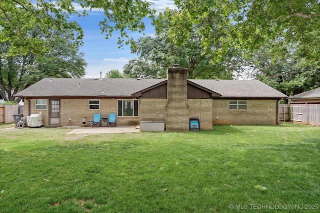 7329 E 66th Ct, Tulsa, OK 74133 - back of house featuring brick siding, a patio, and a chimney