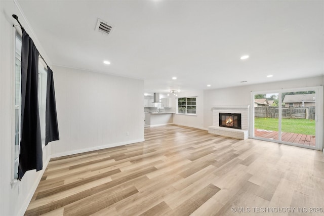 816 W Birmingham St, Broken Arrow, OK 74011 - unfurnished living room with light wood-style floors, a brick fireplace, baseboards, and recessed lighting