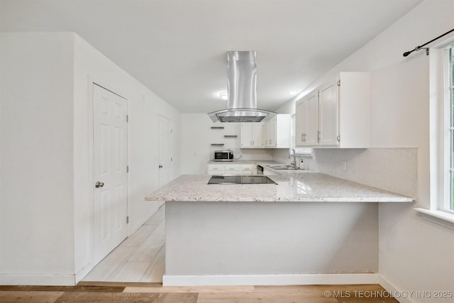 816 W Birmingham St, Broken Arrow, OK 74011 - kitchen featuring stainless steel microwave, island exhaust hood, a peninsula, white cabinetry, and black electric stovetop