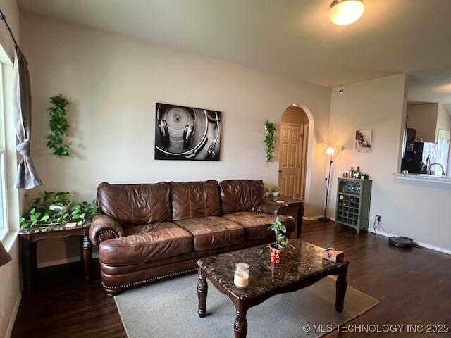 1630 S 31st Ct, Broken Arrow, OK 74014 - living room featuring wood finished floors, arched walkways, and baseboards