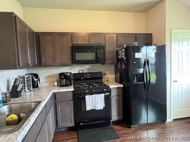 1630 S 31st Ct, Broken Arrow, OK 74014 - kitchen featuring black appliances, dark wood-style floors, a sink, dark brown cabinetry, and light stone countertops