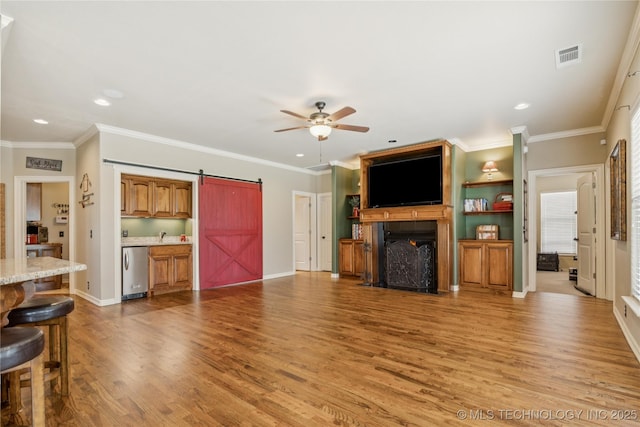 18578 S 269th E Ave, Haskell, OK 74436 - unfurnished living room with a ceiling fan, light wood-style flooring, a fireplace with flush hearth, recessed lighting, and a barn door
