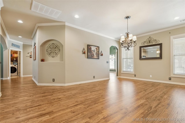 18578 S 269th E Ave, Haskell, OK 74436 - unfurnished room featuring arched walkways, washer / dryer, ornamental molding, light wood-type flooring, and a chandelier