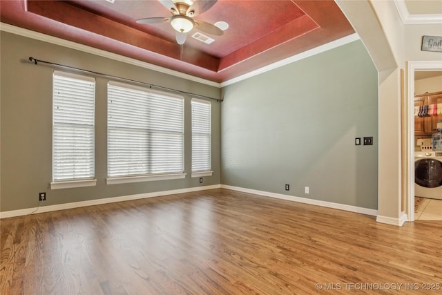 18578 S 269th E Ave, Haskell, OK 74436 - spare room with washer / dryer, a tray ceiling, wood finished floors, ceiling fan, and ornamental molding