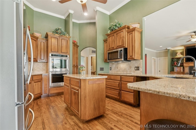 18578 S 269th E Ave, Haskell, OK 74436 - kitchen with appliances with stainless steel finishes, ceiling fan, a sink, decorative backsplash, and arched walkways