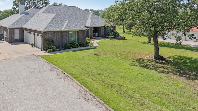 18578 S 269th E Ave, Haskell, OK 74436 - view of front of home with an attached garage, a chimney, brick siding, driveway, and a front lawn