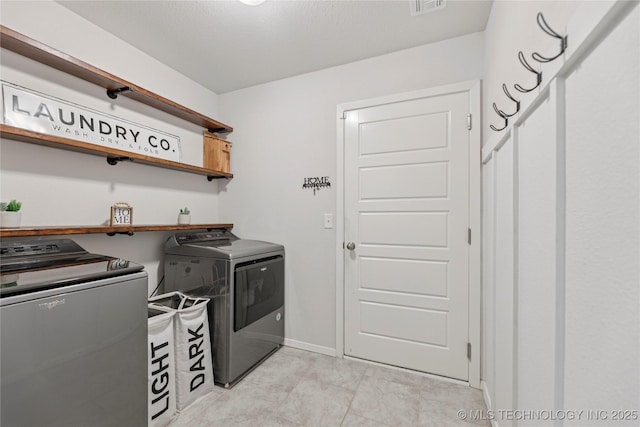 7000 S Elder Ave, Broken Arrow, OK 74011 - laundry area featuring washer and dryer, light tile patterned floors, and baseboards