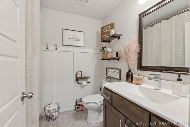 7000 S Elder Ave, Broken Arrow, OK 74011 - bathroom featuring vanity, toilet, and tile patterned flooring
