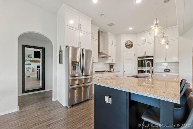 7000 S Elder Ave, Broken Arrow, OK 74011 - kitchen with stainless steel appliances, wall chimney exhaust hood, baseboards, white cabinetry, and recessed lighting