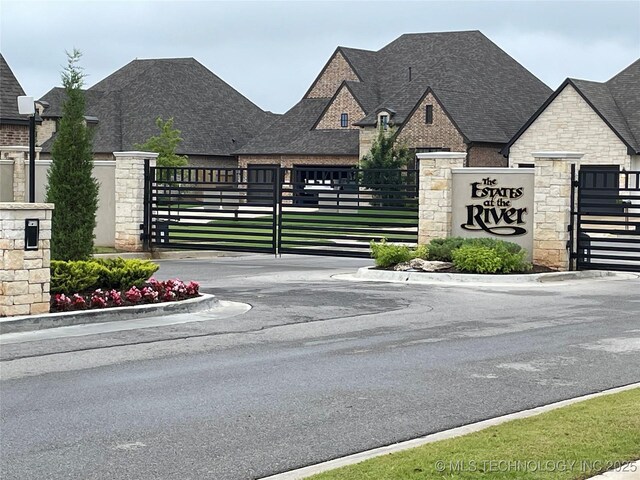 5314 E 125th St S, Bixby, OK 74008 - view of asphalt street with a gate and curbs