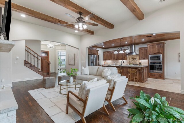 5314 E 125th St S, Bixby, OK 74008 - living area with arched walkways, stairway, a ceiling fan, recessed lighting, and beamed ceiling