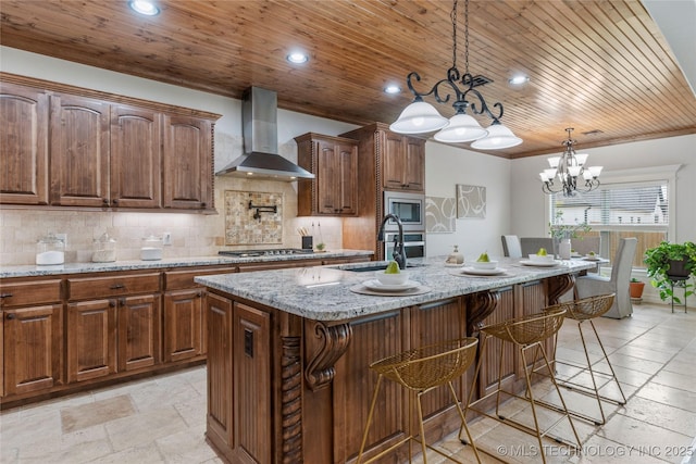 5314 E 125th St S, Bixby, OK 74008 - kitchen with wall chimney exhaust hood, appliances with stainless steel finishes, light stone counters, a sink, and tasteful backsplash