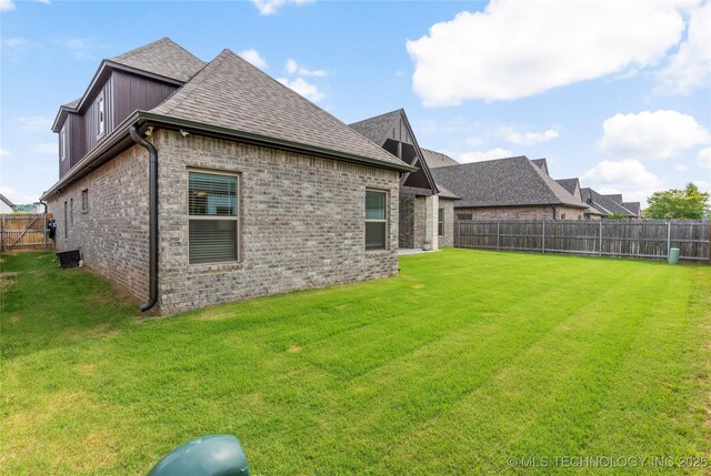 5314 E 125th St S, Bixby, OK 74008 - back of property with a shingled roof and brick siding