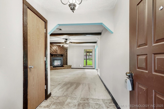 32112 E 721st Rd, Wagoner, OK 74467 - hallway with light colored carpet, baseboards, a textured ceiling, and beam ceiling