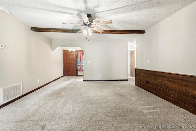 32112 E 721st Rd, Wagoner, OK 74467 - spare room with carpet floors, a textured ceiling, ceiling fan, beam ceiling, and baseboards