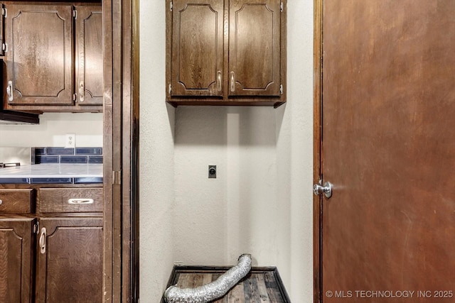 32112 E 721st Rd, Wagoner, OK 74467 - laundry area with hookup for an electric dryer, cabinet space, and a textured wall