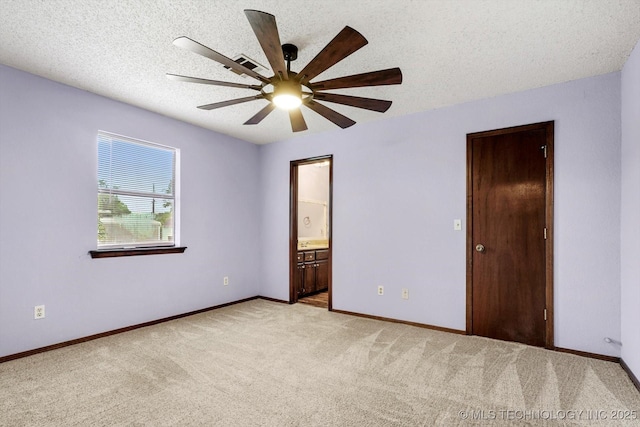 32112 E 721st Rd, Wagoner, OK 74467 - unfurnished bedroom with light carpet, baseboards, a textured ceiling, connected bathroom, and ceiling fan