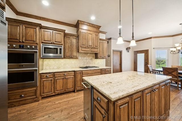 21 E 171st St S, Glenpool, OK 74033 - kitchen featuring stainless steel appliances, light wood-style flooring, ornamental molding, tasteful backsplash, and a kitchen island