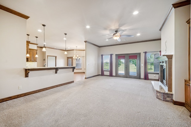 21 E 171st St S, Glenpool, OK 74033 - unfurnished living room with light carpet, ceiling fan, ornamental molding, a brick fireplace, and recessed lighting