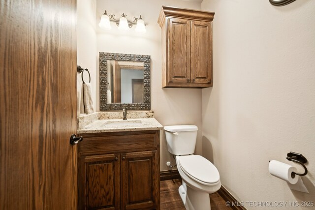21 E 171st St S, Glenpool, OK 74033 - bathroom featuring toilet, vanity, baseboards, and wood finished floors