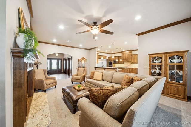 21 E 171st St S, Glenpool, OK 74033 - living area featuring arched walkways, ornamental molding, ceiling fan, recessed lighting, and light colored carpet