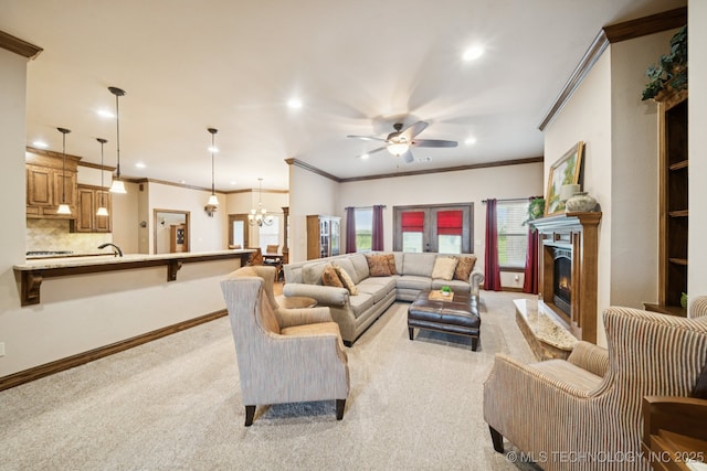 21 E 171st St S, Glenpool, OK 74033 - living room featuring light colored carpet, a ceiling fan, ornamental molding, a warm lit fireplace, and recessed lighting