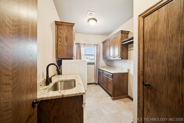 21 E 171st St S, Glenpool, OK 74033 - kitchen featuring a sink, light stone counters, and baseboards